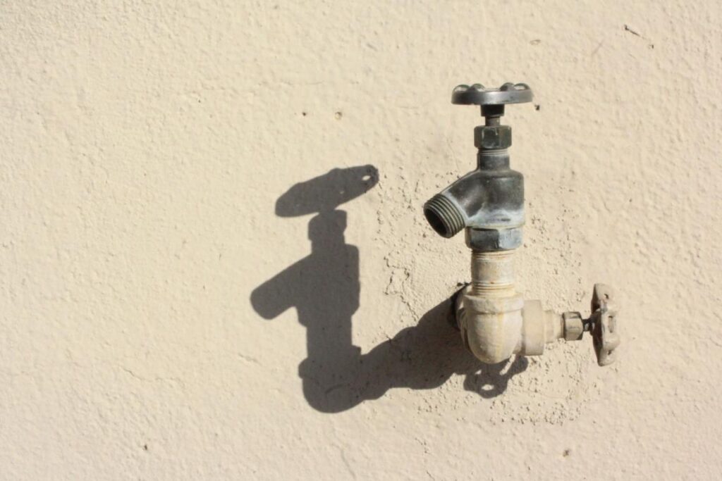 Water Spigot On Beige Wall