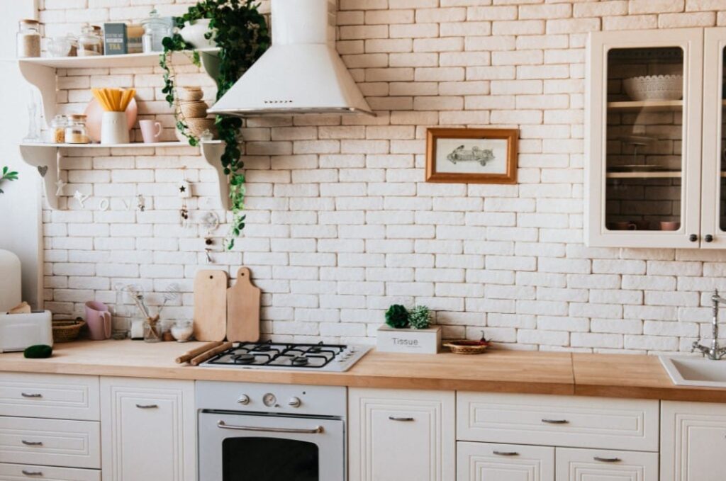 Kitchen With White Brick Walls And Wooden Countertops